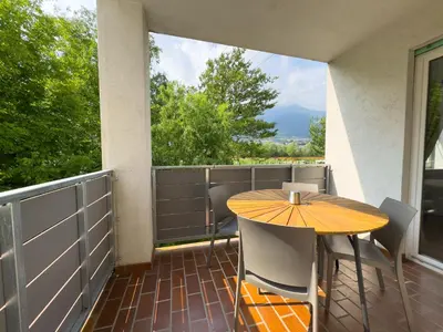 a patio with a table and chairs on a balcony at Apartment Annabell - Alpstay in Naturno