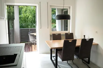 a dining room with a wooden table and chairs at Apartment Annabell - Alpstay in Naturno