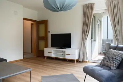 a living room with a flat screen tv on a white cabinet at Apartment Annabell - Alpstay in Naturno