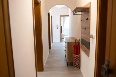 a hallway with an archway leading into a room at Apartment Annabell - Alpstay in Naturno