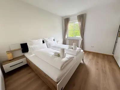 a bedroom with two beds with white sheets and a window at Apartment Annabell - Alpstay in Naturno