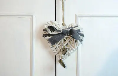 a wicker heart hanging on a door at Albergo al Sole in Val di Zoldo