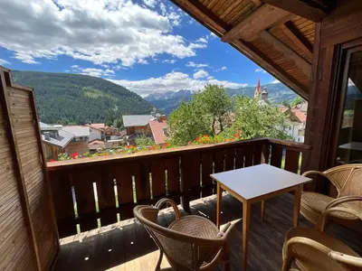 a balcony with chairs and a table and a view at Appartements Oberhammer in Tesido
