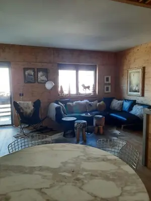 a living room with a blue couch and chairs at Esclusivo soggiorno a Cortina d'Ampezzo in Cortina dʼAmpezzo