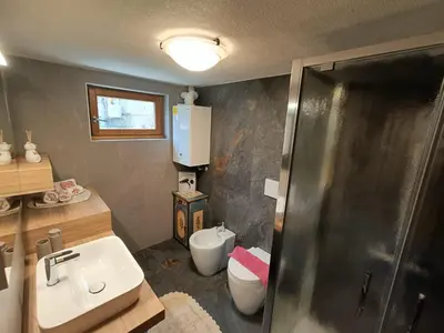 a bathroom with a shower and a sink and a toilet at Casa Soraya 2 in Falcade