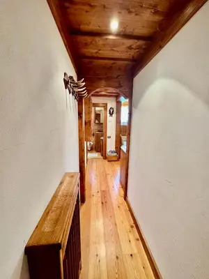 a hallway in a house with a wooden ceiling at Ca del Rio - Cortina in Cortina dʼAmpezzo