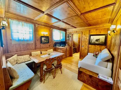 a living room with a couch and a table in a train at Ca del Rio - Cortina in Cortina dʼAmpezzo