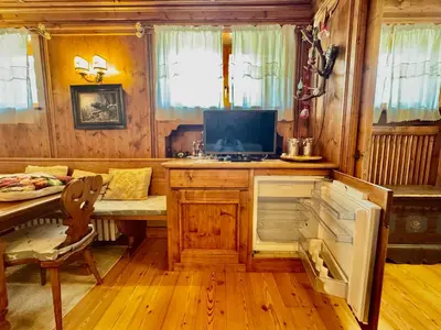 a kitchen with a desk and a table and a chair at Ca del Rio - Cortina in Cortina dʼAmpezzo
