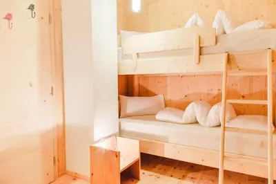 a bunk bed room with two bunk beds at Forest Chalet Resort FELIZITAS in San Felice