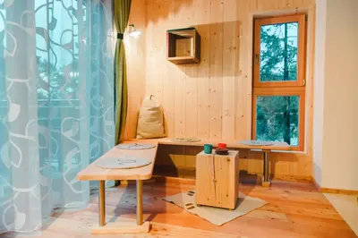 a room with two tables and a window at Forest Chalet Resort FELIZITAS in San Felice