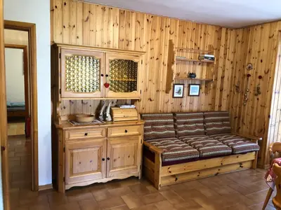a room with a bench and a wooden wall at Casa Solidea in Moena