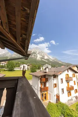 a person sitting on the roof of a building at Casa Scoiattolo, con balcone panoramico in San Vito di Cadore