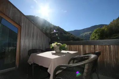 a table and chairs on a balcony with a view at Ferienwohnung Pirchner in San Lorenzo di Sebato