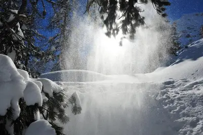 a waterfall in the snow with snow covered trees at Ferienwohnung Pirchner in San Lorenzo di Sebato