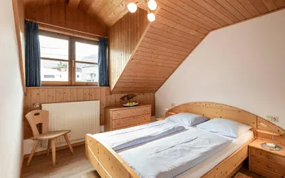 a bedroom with a large bed and a wooden ceiling at Moarhof Albeins in Albes