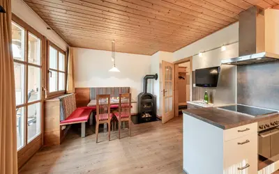 a kitchen and dining room with a table and chairs at Moarhof Albeins in Albes