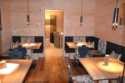 a dining room with wooden tables and chairs at Hotel Ortler in Castelrotto