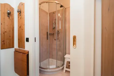 a bathroom with a shower and a toilet at Hotel Oasi in Cortina dʼAmpezzo