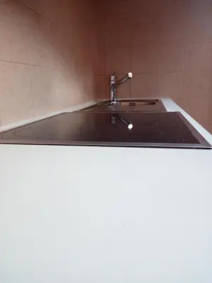 a kitchen sink with a faucet on top of it at Digart apartment in Ortisei