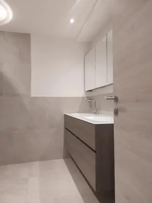 a bathroom with a sink and a white cabinet at Digart apartment in Ortisei