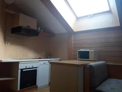 a kitchen with a stove and a microwave at Digart apartment in Ortisei