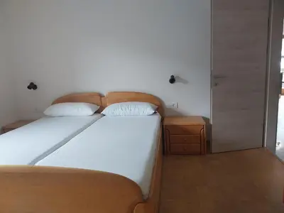 a bed with two white pillows on top of it at Digart apartment in Ortisei