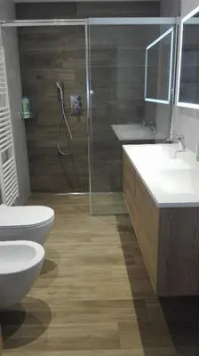 a bathroom with a shower and a toilet and a sink at Digart apartment in Ortisei
