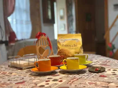 a table with cups and saucers on a table at 1500-year-old El Molin Cottage in the heart of Moena in Moena