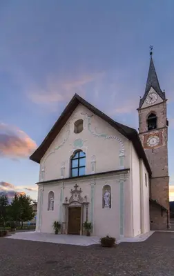 a large white church with a clock tower at La casa di Nicole in Romeno