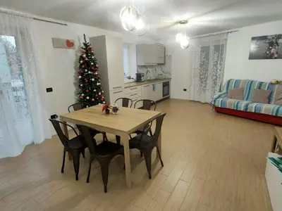 a living room with a table and a christmas tree at La casa di Nicole in Romeno