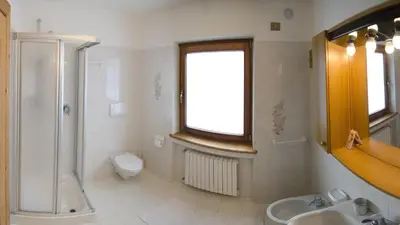 a bathroom with a shower and a toilet and a sink at Villetta Chiave in Chiave