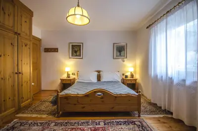 a bedroom with a bed and two lamps on two tables at Villetta Chiave in Chiave
