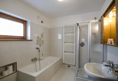 a bathroom with a tub and a sink and a shower at Villetta Chiave in Chiave