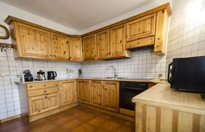 a kitchen with wooden cabinets and a sink at Villetta Chiave in Chiave