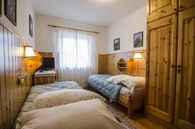 a bedroom with two beds and a window at Villetta Chiave in Chiave
