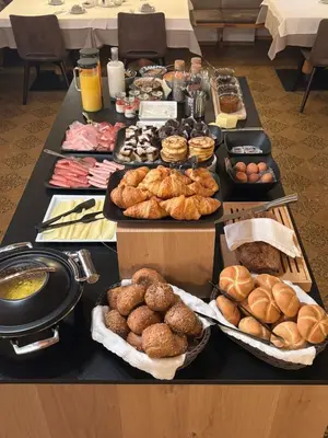 a table topped with lots of different types of pastries at Pension Grohmann in Santa Cristina in Val Gardena
