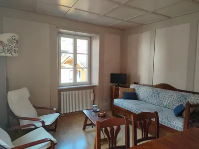 a living room with a couch and a table at Appartamento Maso Tati in Predazzo