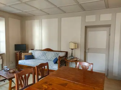 a living room with a table and a couch at Appartamento Maso Tati in Predazzo