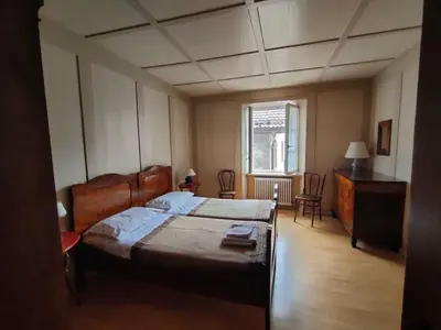 a bedroom with a large bed and a window at Appartamento Maso Tati in Predazzo