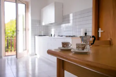 a kitchen counter with two coffee cups on it at Casa Maia in Sanzeno