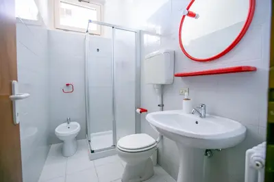 a bathroom with a toilet and a sink and a mirror at Casa Maia in Sanzeno