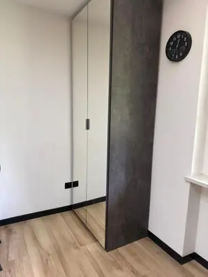 a room with a mirror and a clock on a wall at Regina del bosco in Ronzone