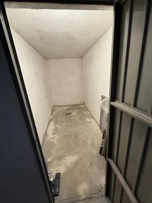 an attic room with an open door to a room at Regina del bosco in Ronzone