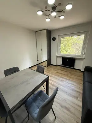 a dining room with a table and chairs and a window at Regina del bosco in Ronzone