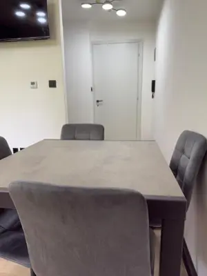 a conference room with a table and chairs at Regina del bosco in Ronzone