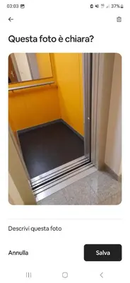 a bathroom with a glass door and a room with yellow walls at Merano appartamento in Merano