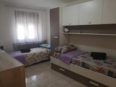 a small bedroom with two beds and a window at Nido del Melo in Cles
