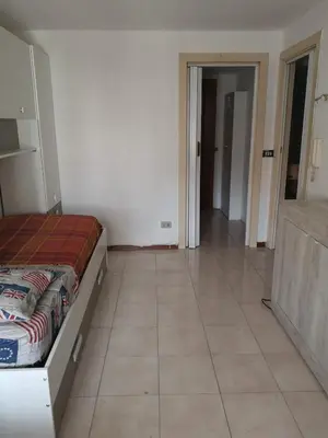 a bedroom with a bed and a tiled floor at Nido del Melo in Cles