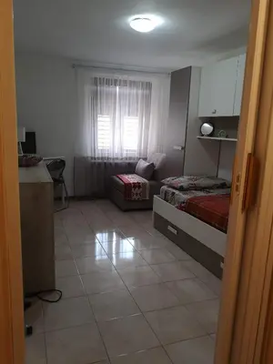 a small bedroom with a bed and a window at Nido del Melo in Cles
