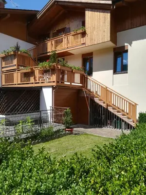 a building with a balcony with plants on it at Casa Alice in Mezzano